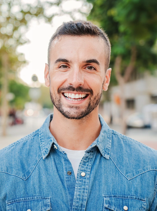 Confident smiling man with bright white teeth after KöR whitening treatment