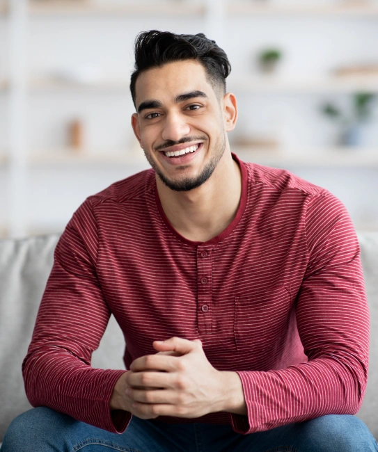 Young man smiling confidently with restored healthy teeth after restorative dentistry treatment