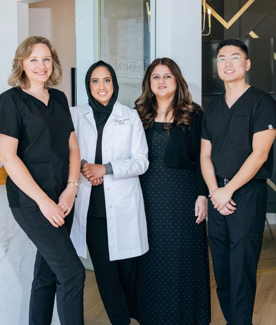 Seven Bridges Dental Studio team of dentist and staff smiling and taking photo together inside the dental office in Woodridge, IL