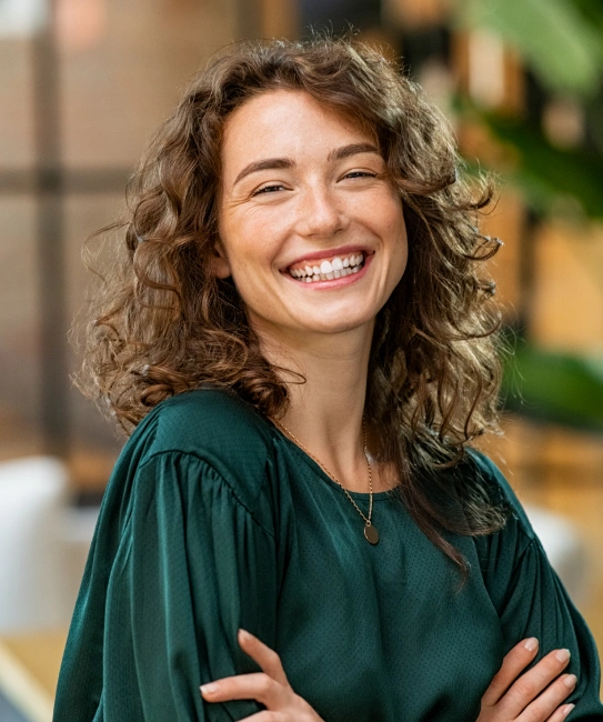 Happy woman with beautiful smile after complete smile makeover treatment